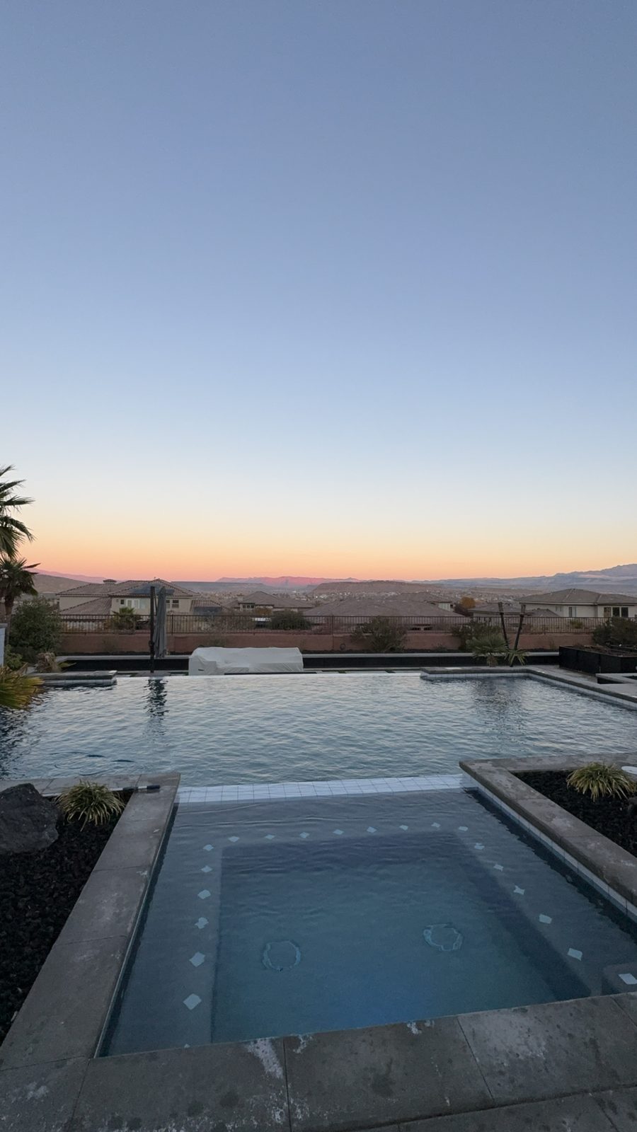 Pool and spa at dusk with mountain view